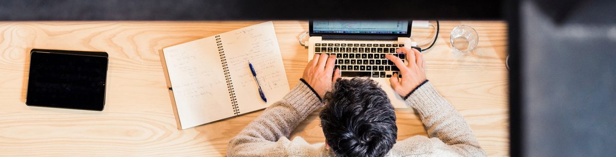 looking down on a hot desk and person working